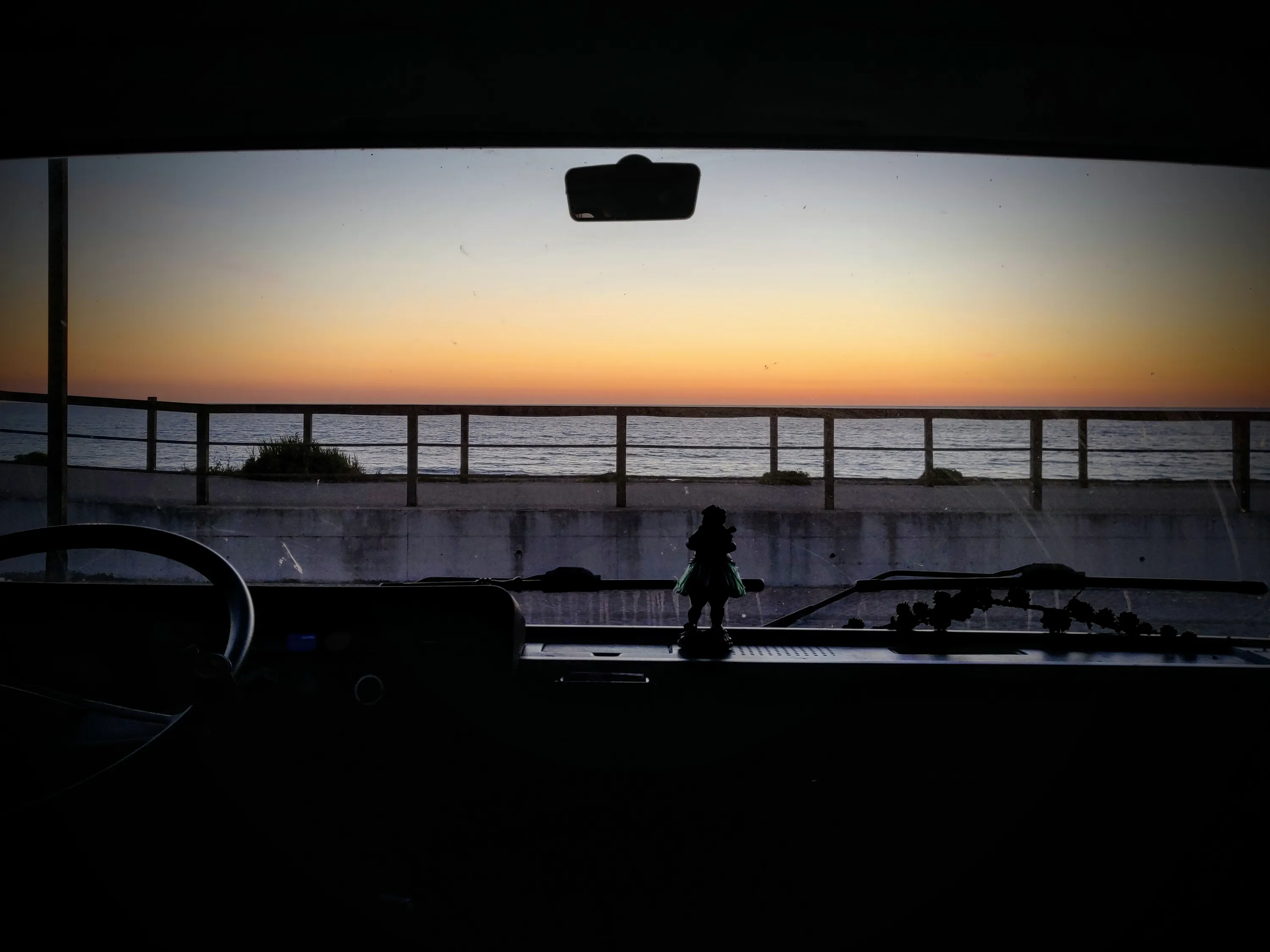 Uitzicht door de voorruit van de camper bij zonsondergang — slimme automatisering onderweg